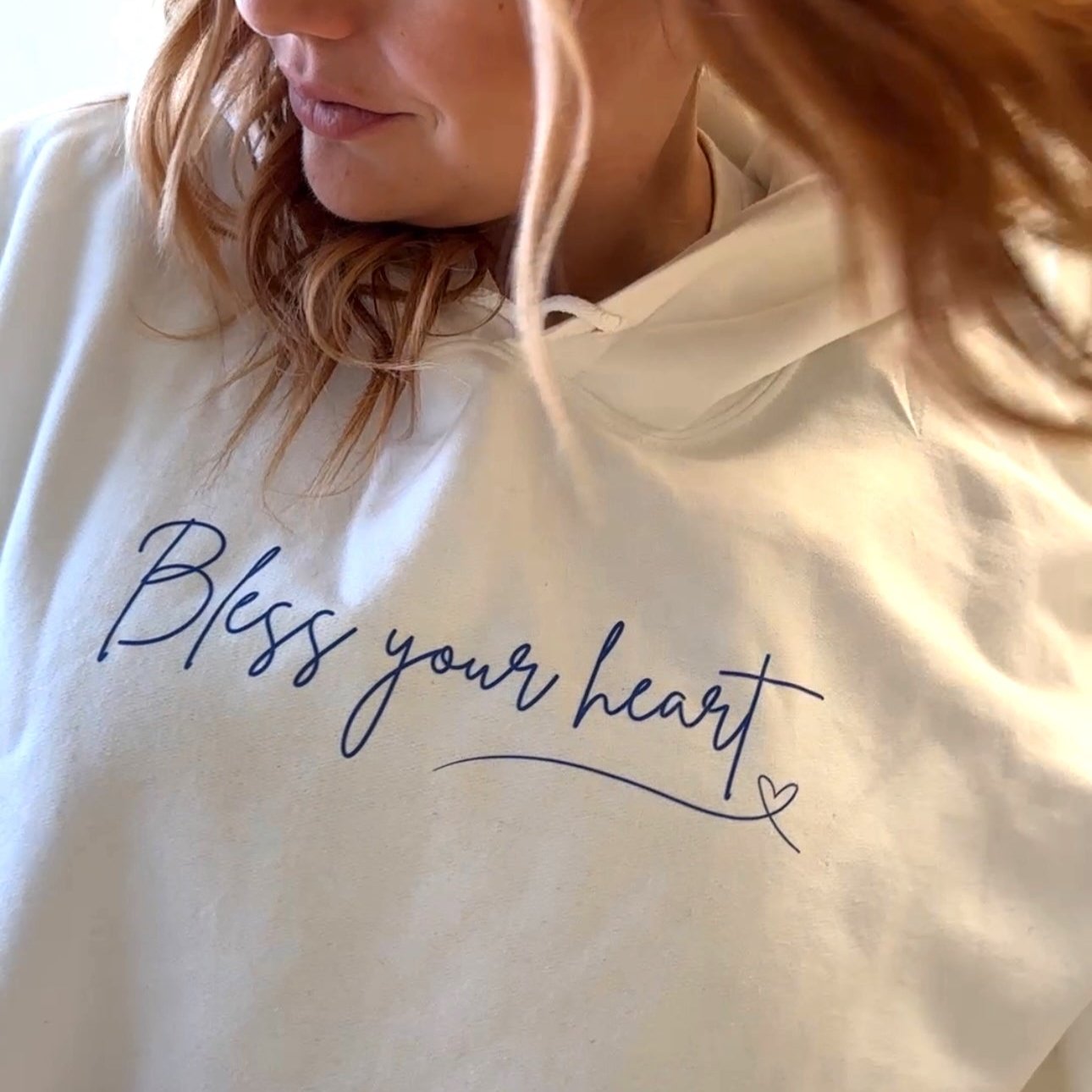 White hoodie with blue writing. Bless your heart