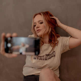 sand tshirt with brown cowboy cushions across the chest 