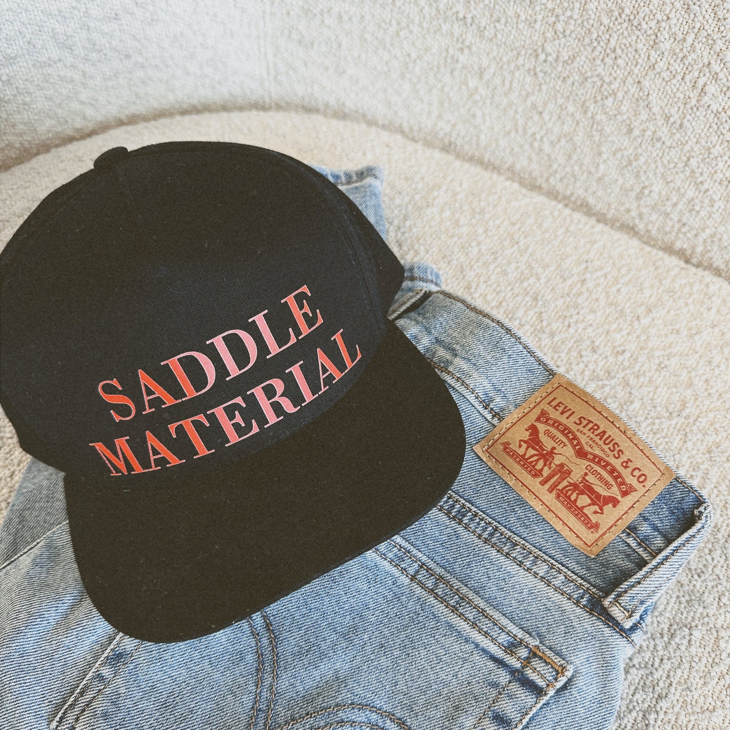 SADDLE MATERIAL TRUCKER HAT