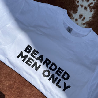 White tshirt with bold black text stating BEARDED MEN ONLY on a brown and white cow print background 