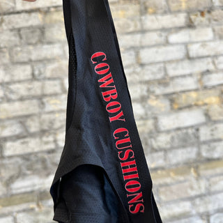 1 black thong underwear featuring the 'COWBOY CUSHIONS' logo. The item is displayed on a beige textured surface.