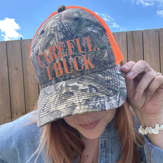CAREFUL, I BUCK CAMO TRUCKER HAT