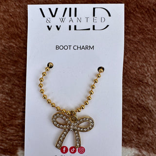 Gold boot charm on a white card with 'Wild & Wanted' branding.
